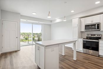 a large kitchen with white cabinets and a white counter top